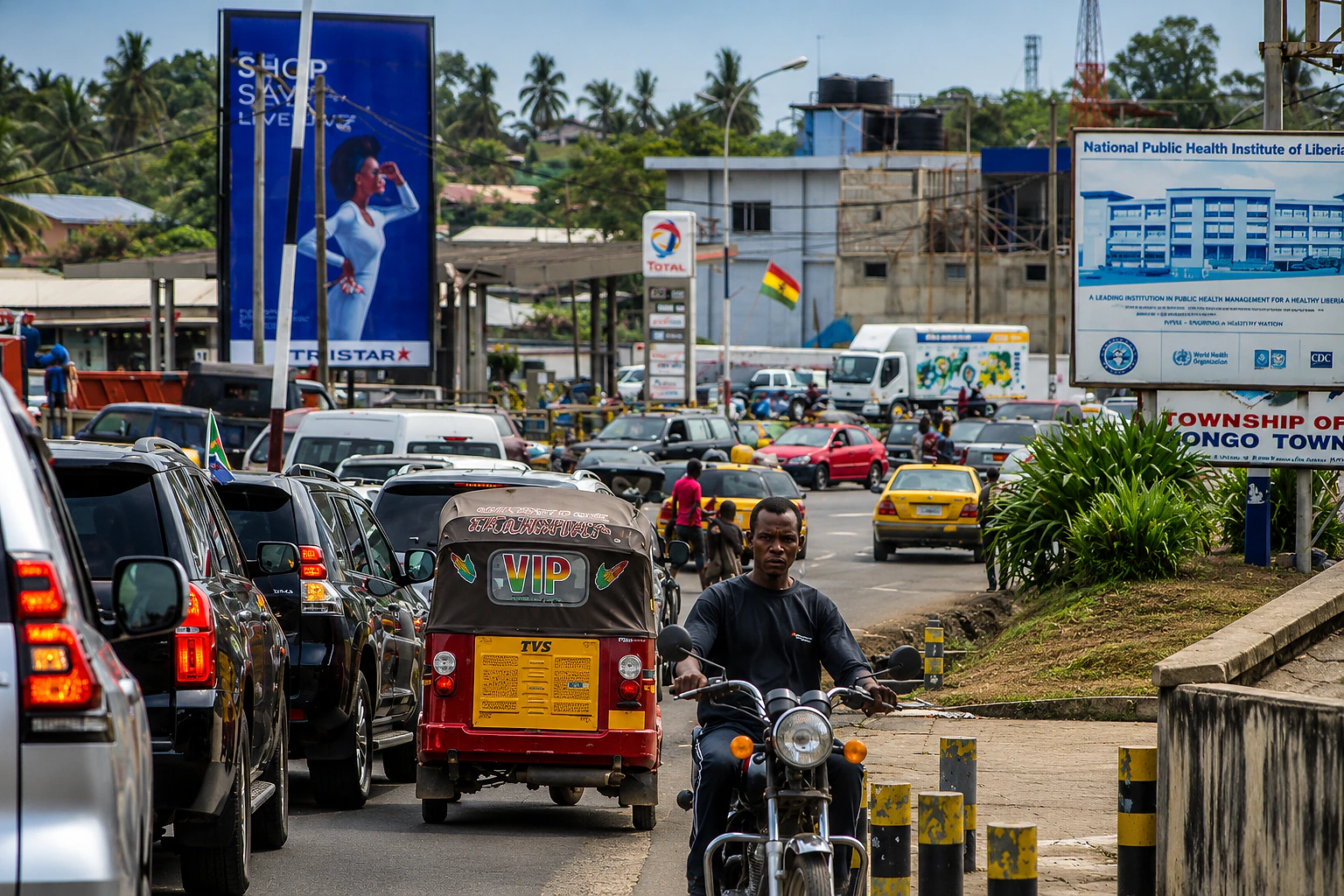 Commercial vehicles and mobile phone towers along a Monrovia road